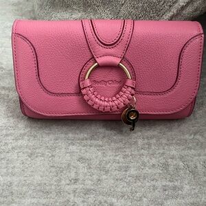 See By Chloe pink wallet on a chain
